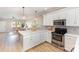 Open kitchen featuring white cabinets, modern appliances, and easy access to living room at 121 Quality Dr, Mount Holly, NC 28120