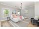 Spacious main bedroom featuring neutral walls, large windows for ample light, and a plush seating area at 121 Quality Dr, Mount Holly, NC 28120