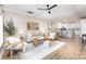 Inviting open concept living space with light-colored walls, ceiling fan, and adjacent kitchen at 121 Quality Dr, Mount Holly, NC 28120