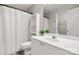 Bathroom with white vanity, open shelves, and shower-tub combination at 1305 Dan Dr, Rock Hill, SC 29732