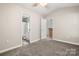 Bedroom offering a bathroom and kitchen view, neutral paint, and carpet flooring at 1305 Dan Dr, Rock Hill, SC 29732