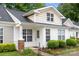 Charming home with landscaped front yard, brick accents, and covered porch, perfect for relaxing outdoors at 1305 Dan Dr, Rock Hill, SC 29732