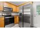 Modern kitchen showcasing stainless steel appliances, wood cabinetry, and functional layout at 1305 Dan Dr, Rock Hill, SC 29732
