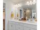 Bright bathroom featuring double sinks, a large mirror, and a walk-in shower at 13327 Savaine St, Charlotte, NC 28278