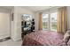 Bright bedroom with a large window, TV, and shelving at 13327 Savaine St, Charlotte, NC 28278