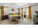 Bright bedroom featuring a decorative tray ceiling, large window, and yellow accents at 13327 Savaine St, Charlotte, NC 28278