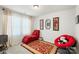 Comfortable bedroom featuring a chaise lounge, decorative artwork, and natural light at 13327 Savaine St, Charlotte, NC 28278