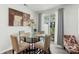 Bright dining area featuring a glass table, stylish chairs, and sliding glass doors to the outdoor area at 13327 Savaine St, Charlotte, NC 28278