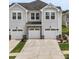 Beautiful townhome exterior featuring attached garages and manicured landscaping in a desirable neighborhood at 13327 Savaine St, Charlotte, NC 28278