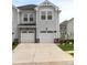 Charming townhome with a two-car garage, stone accents, and well-maintained landscaping at 13327 Savaine St, Charlotte, NC 28278