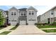Attractive townhome with two-car garage, neutral siding, and well-kept landscaping at 13327 Savaine St, Charlotte, NC 28278