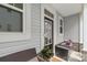 Welcoming front porch featuring stone accents, a cozy bench, and decorative potted plants at 13327 Savaine St, Charlotte, NC 28278