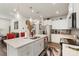Open-concept kitchen with large island, stainless steel appliances, modern lighting, and seamless flow to the living area at 13327 Savaine St, Charlotte, NC 28278