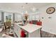 Open-concept kitchen featuring a spacious island with seating, stainless steel appliances, and seamless flow to the dining and living areas at 13327 Savaine St, Charlotte, NC 28278