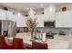 Bright kitchen featuring a large island with barstool seating, stainless steel appliances, and modern lighting fixtures at 13327 Savaine St, Charlotte, NC 28278