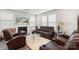 Inviting living room with a cozy fireplace, plush leather seating, and a large flatscreen television at 13327 Savaine St, Charlotte, NC 28278
