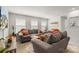 Comfortable living room with neutral-toned sofas, a flatscreen TV, and natural light filtering through the windows at 13327 Savaine St, Charlotte, NC 28278