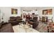 Open-concept living space with leather furniture, a modern kitchen, and a dining area with stylish seating at 13327 Savaine St, Charlotte, NC 28278