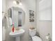 Chic powder room with a pedestal sink, elegant mirror, and stylish fixtures, offering a touch of sophistication at 13327 Savaine St, Charlotte, NC 28278