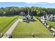 Expansive aerial view of a luxurious home with a large, well-manicured lawn and a gated entrance at 1405 Waxhaw Marvin Rd, Waxhaw, NC 28173