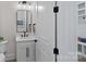 This is a well-lit powder room with sleek black fixtures, a white vanity, and a modern mirror, offering a stylish and functional space at 1405 Waxhaw Marvin Rd, Waxhaw, NC 28173