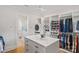 This well-organized walk-in closet features custom shelving, an island with drawers, and ample storage for clothing and accessories at 1405 Waxhaw Marvin Rd, Waxhaw, NC 28173