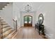 Inviting foyer with hardwood floors, decorative lighting, and an elegant front door at 1405 Waxhaw Marvin Rd, Waxhaw, NC 28173