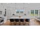 Spacious, white kitchen with a large center island, modern appliances, and pendant lighting at 1405 Waxhaw Marvin Rd, Waxhaw, NC 28173