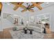 Bright, modern living room featuring exposed wood beams, stylish furniture, and open access to the kitchen at 1405 Waxhaw Marvin Rd, Waxhaw, NC 28173