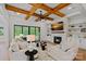Inviting living room with beamed ceilings, stone fireplace, and sliding glass doors to outdoor patio at 1405 Waxhaw Marvin Rd, Waxhaw, NC 28173