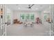 This spacious playroom is filled with natural light, featuring plush carpeting and ample space for toys and activities at 1405 Waxhaw Marvin Rd, Waxhaw, NC 28173