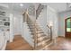 Staircase featuring hardwood steps, black iron railings, and natural light at 1405 Waxhaw Marvin Rd, Waxhaw, NC 28173