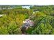 Stunning aerial view of a luxury home nestled among lush trees near the water at 167 Quaker Rd, Mooresville, NC 28117