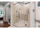 Modern bathroom features a glass shower and custom tile design, and neutral colors at 167 Quaker Rd, Mooresville, NC 28117