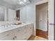 Bright bathroom with double vanity, white cabinetry, tile floors, and dual doorways at 167 Quaker Rd, Mooresville, NC 28117