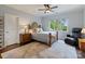 Bedroom boasts a ceiling fan, dark wood floors, large windows, and a leather recliner at 167 Quaker Rd, Mooresville, NC 28117