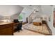 Spacious bedroom with dormer window, a ceiling fan, and a cozy seating area at 167 Quaker Rd, Mooresville, NC 28117