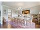 Elegant dining room with classic chandelier, wainscoting and hardwood flooring at 167 Quaker Rd, Mooresville, NC 28117