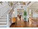 Bright foyer with grand staircase, hardwood floors, and views into the living spaces at 167 Quaker Rd, Mooresville, NC 28117