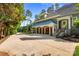 View of the large driveway and garage with wooden doors, covered by a light teal canopy at 167 Quaker Rd, Mooresville, NC 28117