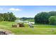 Scenic golf course view with a lake, lush greenery, and manicured lawns at 167 Quaker Rd, Mooresville, NC 28117