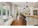Open concept kitchen with hardwood floors, large island with seating, and sunroom views at 167 Quaker Rd, Mooresville, NC 28117