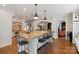 Spacious kitchen with granite counters, island, stainless appliances, hardwood floors, and seating at 167 Quaker Rd, Mooresville, NC 28117