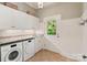 Functional laundry room with ample storage, and exterior access at 167 Quaker Rd, Mooresville, NC 28117