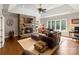 Cozy living room with stone fireplace, beamed ceiling, hardwood floors, and large windows at 167 Quaker Rd, Mooresville, NC 28117