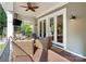 Inviting covered porch with stylish seating, a fire pit, and a ceiling fan at 167 Quaker Rd, Mooresville, NC 28117