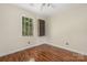 Bedroom with hardwood floors, ceiling fan, and natural light from one window at 172 Valleybrook Dr # 8, Denver, NC 28037