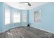 Bright blue bedroom with modern flooring and large windows for natural light at 172 Valleybrook Dr # 8, Denver, NC 28037