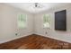 The bedroom has hardwood floors, natural light from two windows, and a ceiling fan at 172 Valleybrook Dr # 8, Denver, NC 28037
