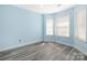 Light blue bedroom with new flooring and multiple windows with blinds at 172 Valleybrook Dr # 8, Denver, NC 28037